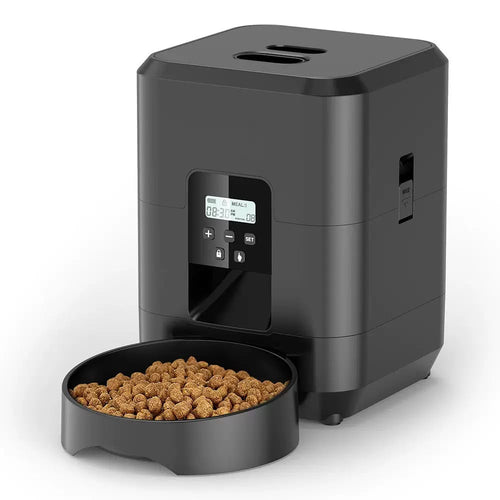 Automatic pet feeder with LCD timer display and removable food bowl filled with dry kibble